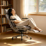 Woman relaxing on Reiko Apex ergonomic chair reclined at home